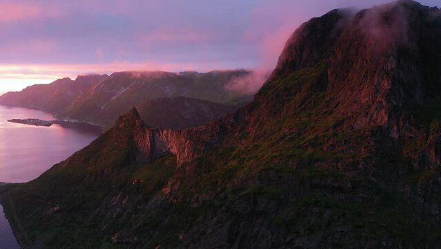 Sunset over Fjord and Mountain on Senja Island in Norway, aerial view from drone