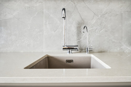Front view of a stone sink and water tap for pure water