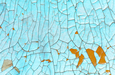 Cracked blue paint on the surface of the old wall as a background