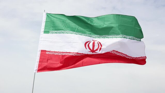Iran flag waving against the blue sky. High quality 4k footage