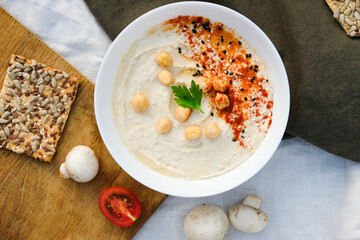 Healthy vegan homemade Hummus with olive oil and paprika with Chips. Homemade Hummus bowl Authentic cuisine. 