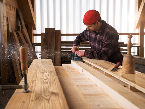 Carpenter working with hand tool at workshop