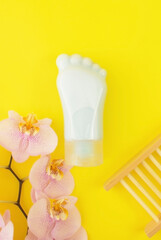 Tube-container for cosmetic foot cream. Concept of natural cosmetics and skin care. Set of pedicure tools. Studio shot with copy space, empty, unfilled. Vertical photo