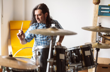 Musician playing drum at home