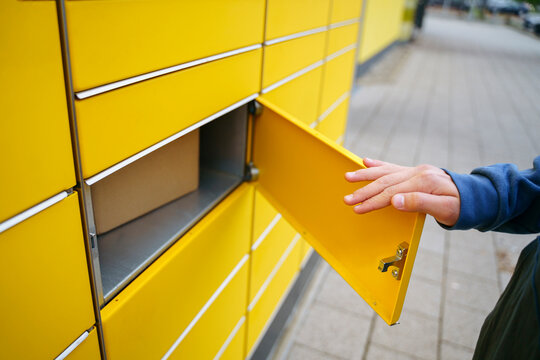 Hand of boy opening parcel locker