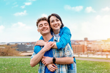 a young woman and a man met and hugged in the park on a walk