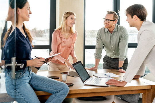 Happy Business Colleagues Having Discussion In Office