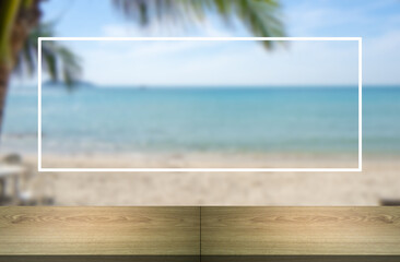 Wooden table with white striped frame. Beach background, palm leaves, coconut leaves and blur.
