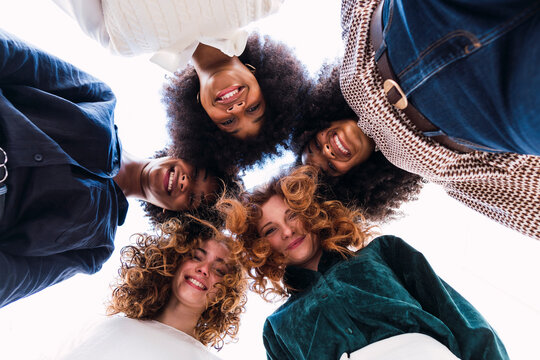 Happy businesswomen huddling together in unity