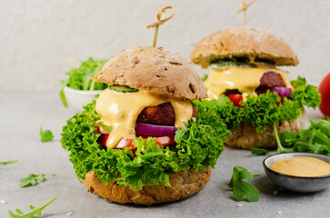 Delicious Burgers with Vegetables and Sauce, Fresh and Tasty Plant Based Meatless Burgers on Bright Background