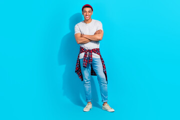 Full size photo of cheerful satisfied young person crossed hands posing good mood isolated on blue color background