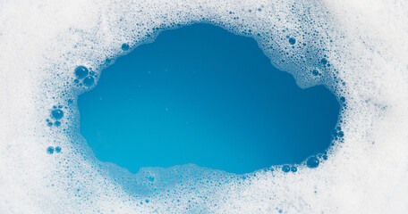 Detergent foam bubble on water. Blue background, Soap sud