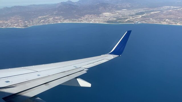 Commercial aircraft flying over the Gulf of California that separates the Gulf of California from the Pacific Ocean in southern Mexico, heading towards Cape Saint Luke International Airport.
