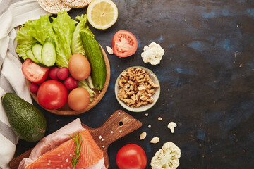 Fodmap Mediterranean diet with copy space. Healthy low fodmap ingredients - vegetables, fruits, nuts, greens, avocado. Flat lay.