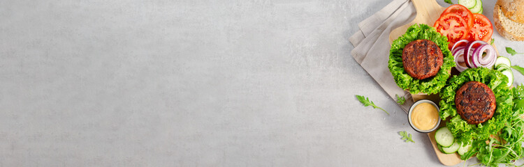Freshly Grilled Burger Patties,Plant Based Meatless Burgers with Fresh Vegetables on a Wooden Board on Bright Background