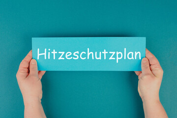 Heat protection plan stands in german language on the paper, regulation for warm summer days,...