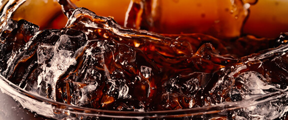 Splashing of Cola and Ice. Cola soda and ice splashing fizzing or floating up to top of surface....