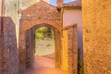 San Gimignano, Tuscany, Italy arch, old medeival street in typical Tuscan town, popular tourist destination