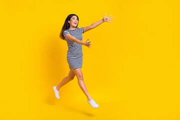 Fototapeta na wymiar Full length photo of sweet impressed woman dressed striped outfit hugging embracing empty space isolated yellow color background