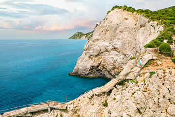 Person on stairs on cliff by the sea