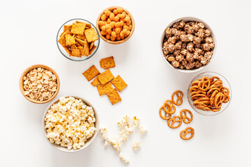 Bowls with different salty snacks for party. Fast food background