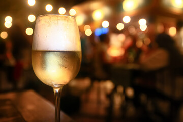 a glass of white wine in a restaurant, alcohol luxury background