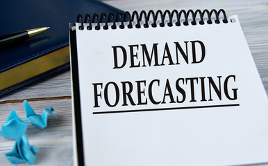 DEMAND FORECASTING - words in a notebook on the background of a weekly and a pen.
