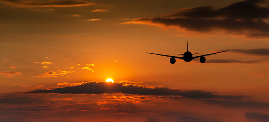 Fototapeta na wymiar Passenger plane on the background of the sunset sky