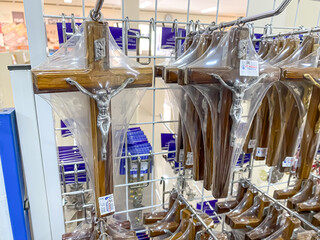 Many statue of Crucified Jesus in a display case of a Catholic spiritual shop. The Cross of Jesus....