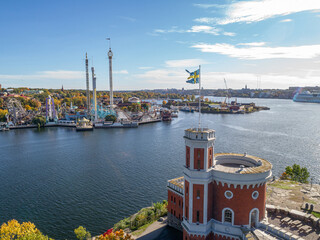 View of amusement park Grona Lund with carousels and tour rides on Djurgarden island Stockholm...