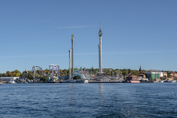 View of amusement park Grona Lund with carousels and tour rides on Djurgarden island Stockholm Sweden
