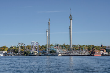 View of amusement park Grona Lund with carousels and tour rides on Djurgarden island Stockholm Sweden