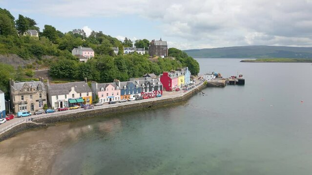 An aerial drone video of Tobermory on the Isle of Mull in Scotland. A small town with colourful houses. 