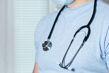 Medical doctor or physician in blue gown uniform with stethoscope in hospital or clinic