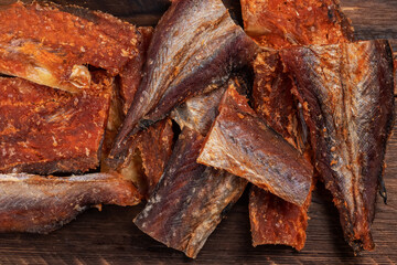 Pieces of cleaned dried fishbackground. Dry Peppered Pollack. Amber with pepper Collection