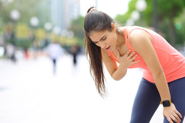 Exhausted runner touching chest in the street - obrazy, fototapety, plakaty