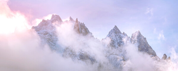Fantastic dawn snow mountains landscape background. Colorful pink and blue clouds overcast sky. French Alps, Chamonix Mont-Blanc, France