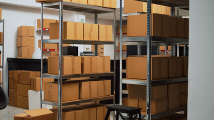 Startup business space filled with merchandise in boxes to ship to clients, products in cardboard...
