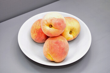Naklejka na ściany i meble ripe juicy peaches on a gray background