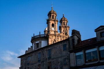 Fototapeta na wymiar Bell tower of the Pilgrim Virgin church between old buildings. Photograph taken in Pontevedra, Galicia, Spain.