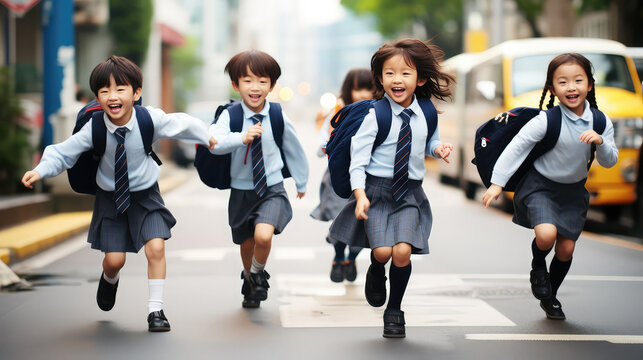 Asian school children wearing school bags running happily back to school