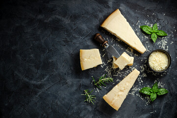 Parmesan cheese. Hard cheese on a dark background. banner, menu, recipe place for text, top view.