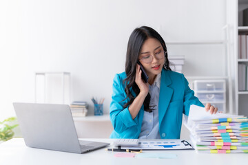 Asian businesswoman modern professional talking with client on the phone with a confident demeanor and effective communication skill. business, marketing, sale and communication project.