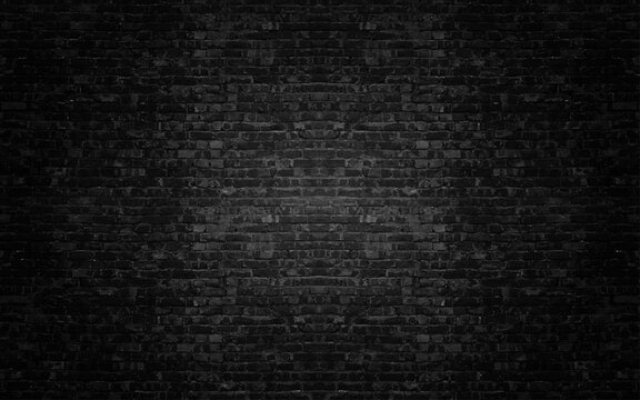 Black brick wall. Construction retro stylish background. Brick texture with scratches and cracks