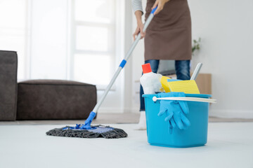 Woman, housewife mopping floor at home.