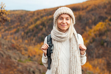 Middle Aged Woman with backpack walking in the autumn forest trip