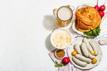 Traditional Oktoberfest set. Beer, weisswurst, smoked pork knuckle eisbein with fermented cabbage