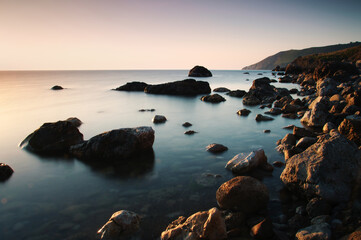 Seascape with rocks and stones on the beach.