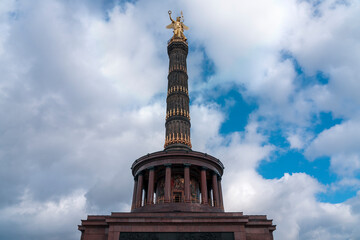 berlin victory column photographed from below with a cloudy sky