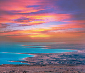 Seascape in the morning with a beautiful dramatic sky. Colorful sunrise over the Dead Sea